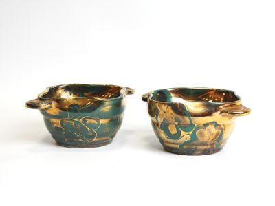 pair of green and gold vases sitting on a white surface