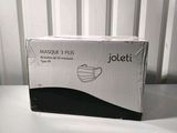 a box that is sitting on a table with a mask on it