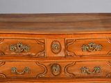a wooden chest of drawers with brass hardware on the drawers