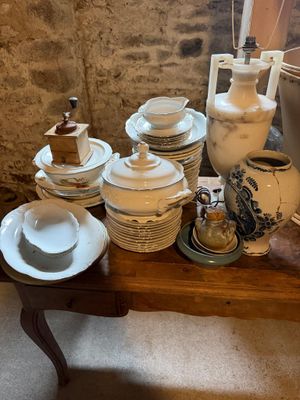 une table sur laquelle se trouvent beaucoup d'assiettes et de bols