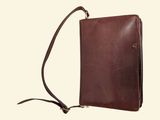 brown leather cross body bag with shoulder strap on a white background
