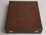 brown leather box on white surface with silver handles
