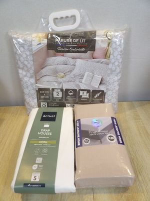 two boxes of bedding on a wooden table