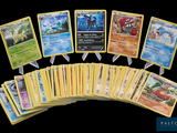 a lot of pokemon cards that are on the table