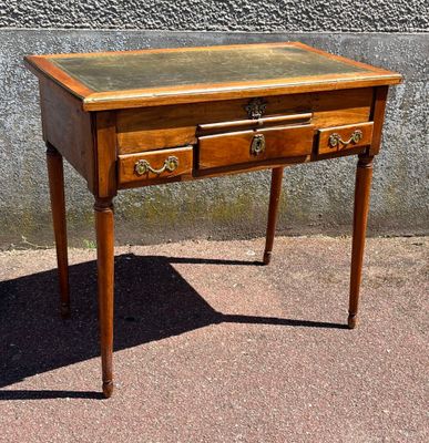 a small wooden table with two drawers on top of it