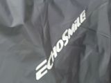 a black motorcycle cover with the word chosme written on it