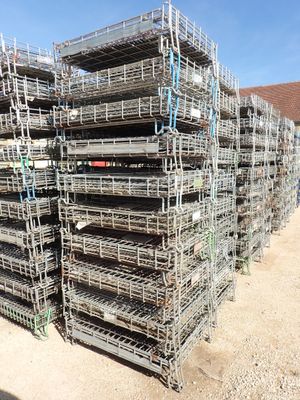 a large pile of metal cages stacked on top of each other
