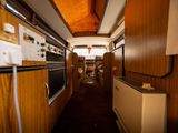 an image of a long narrow kitchen with a stove and oven