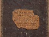 a piece of brown paper with writing on it