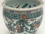 a blue and white bowl with a picture of people on it