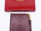an image of a red box with a pen and a brown wallet