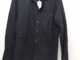 an image of a black jacket hanging on a white wall