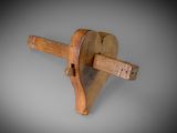 an image of a wooden object with a wooden handle on a gray background
