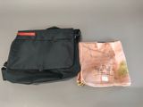 a black bag and a pink bag sitting on a table
