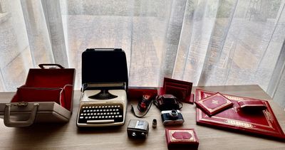 a typewriter sitting on a table next to a window