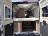 a small bed in the back of a camper van
