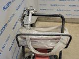 a small cart with a bag on it in a room
