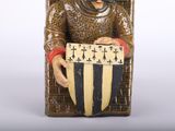 a statue of a man holding a shield and shield