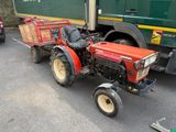 a tractor with a trailer attached to it parked in a parking lot