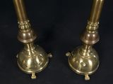pair of antique brass candlesticks on black background