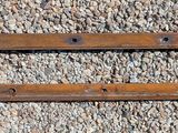 pair of old rusted iron door handles on gravel surface