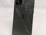an iphone with a cracked screen sitting on a stand