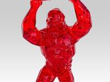 red glass gorilla holding up a sign on a white background