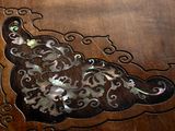 a close up of a wooden table with a decorative design on it