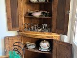 a wooden cabinet that has a lot of dishes inside of it