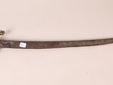 an old dagger with a gold handle on a white surface