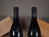 two bottles of wine that are sitting on a table