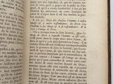 an open book on a white surface with a black border