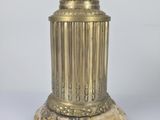 a gold vase with a flower on top of it