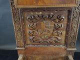 an old wooden cabinet with a coat of arms on it