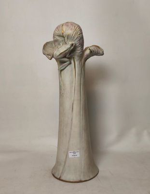 a vase that has a flower in it on a table
