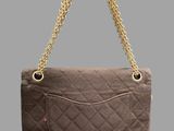 a close up of a brown purse with a gold chain