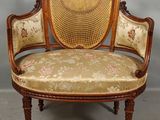 an old fashioned chair with a floral upholstered seat