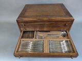 a wooden box with silverware and spoons in it