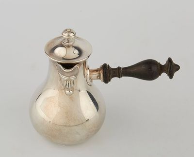 an antique silver coffee pot with a wooden handle