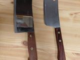 two knives and a knife sharper on a wooden table