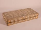 an ornate wooden box with intricate designs on the lid