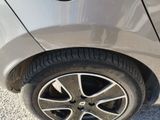a close up of a car ' s tire on the road