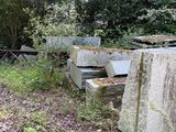 a stone bench sitting in the middle of the woods