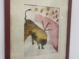 painting of a bull in a frame hanging on a wall