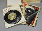 several records are stacked on top of each other on a table