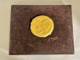 an image of a gold coin sitting on top of a brown box