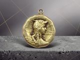 a close up of a gold coin with a woman ' s face on it