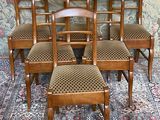six chairs that are sitting on a rug in front of a wall