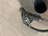 an overhead view of a piece of metal with a wire attached to it