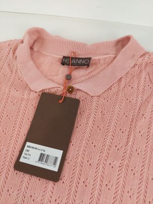 a pink sweater with a tag on it